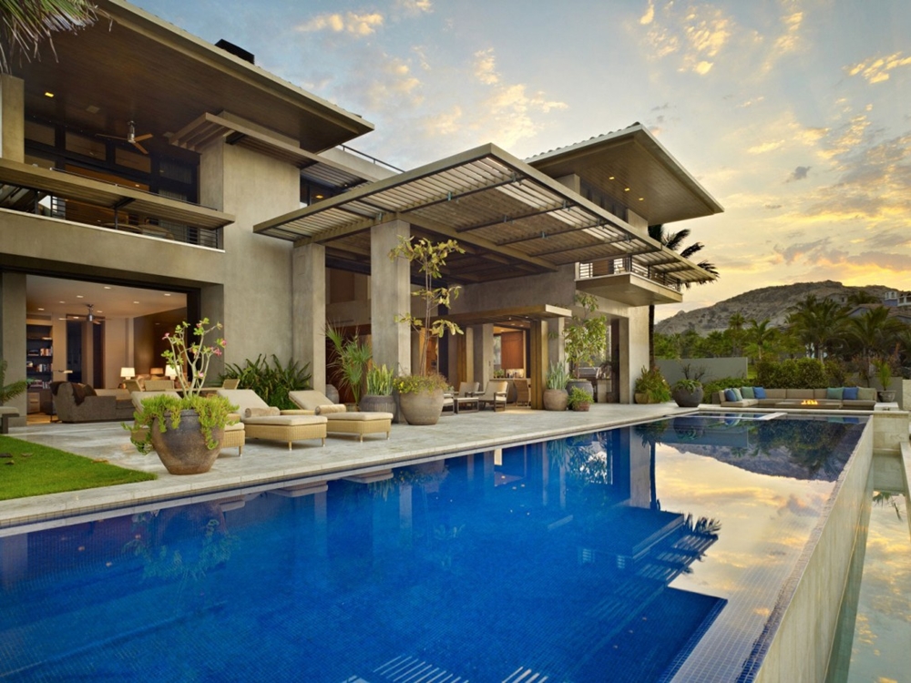 Large swimming pool and stone facade on modern home